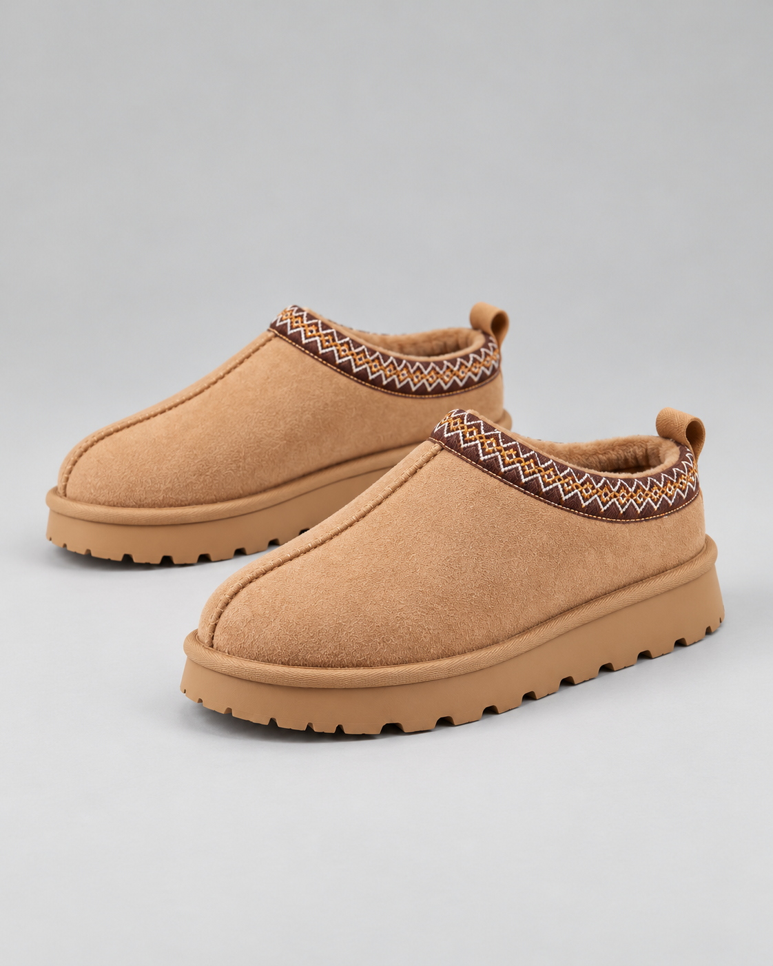 Pair of Slipperella camel Aztec slipper boots on a clean studio background