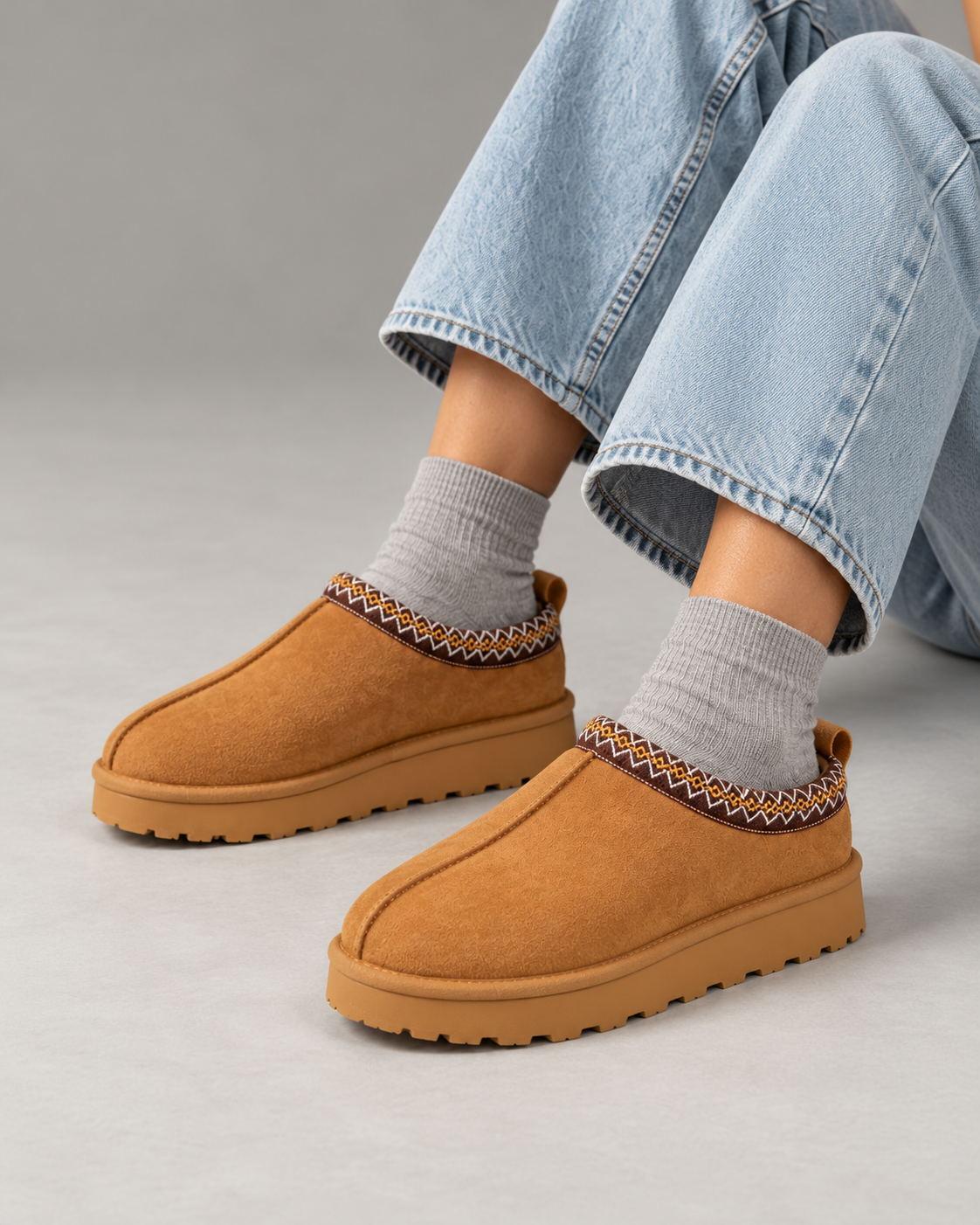 Slipperella caramel Aztec slipper boots in a seated studio pose