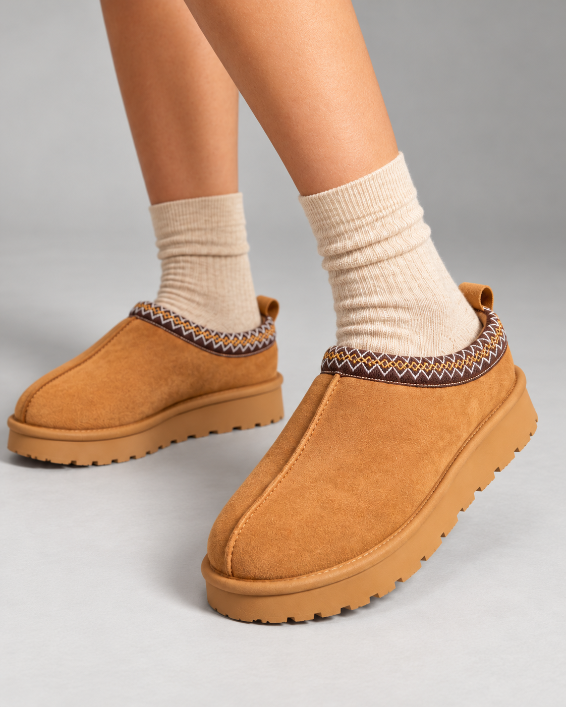 Close-up of Slipperella caramel Aztec slipper boots showing suede texture and embroidered trim