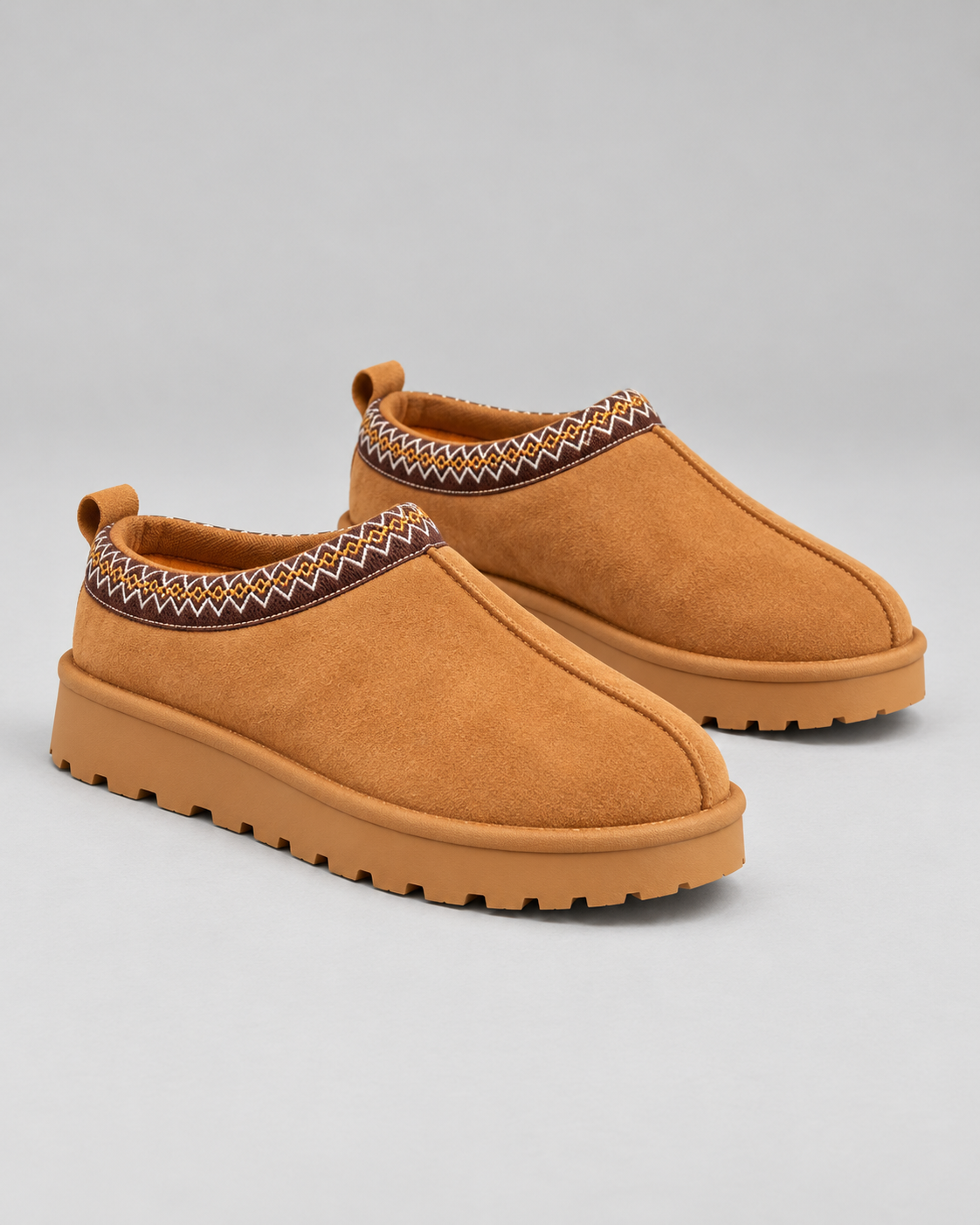 Pair of Slipperella caramel Aztec slipper boots on a clean studio background